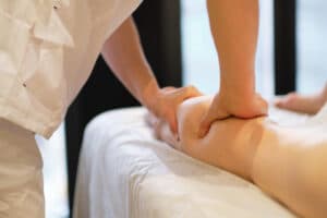 Woman gets her legs massaged to deal with chronic leg swelling.