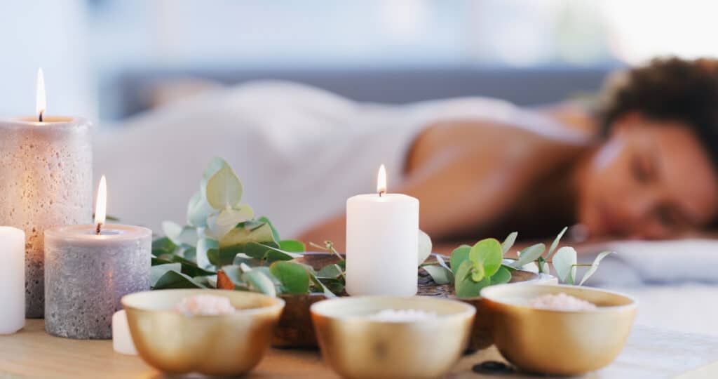 Relax, spa and zen woman with candles for beauty, physical therapy or skincare. Female client on table with candle in ambient room for cosmetics or luxury treatment for skin, health and wellness iStock 1479350890